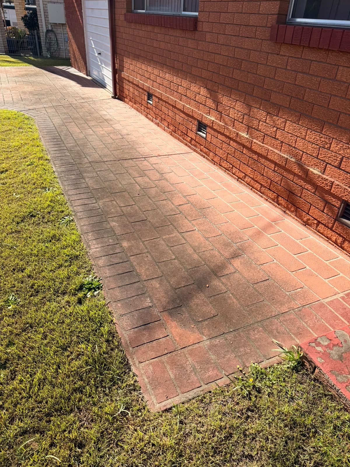 Dirty stained driveway pavers before pressure cleaning, Northern Beaches