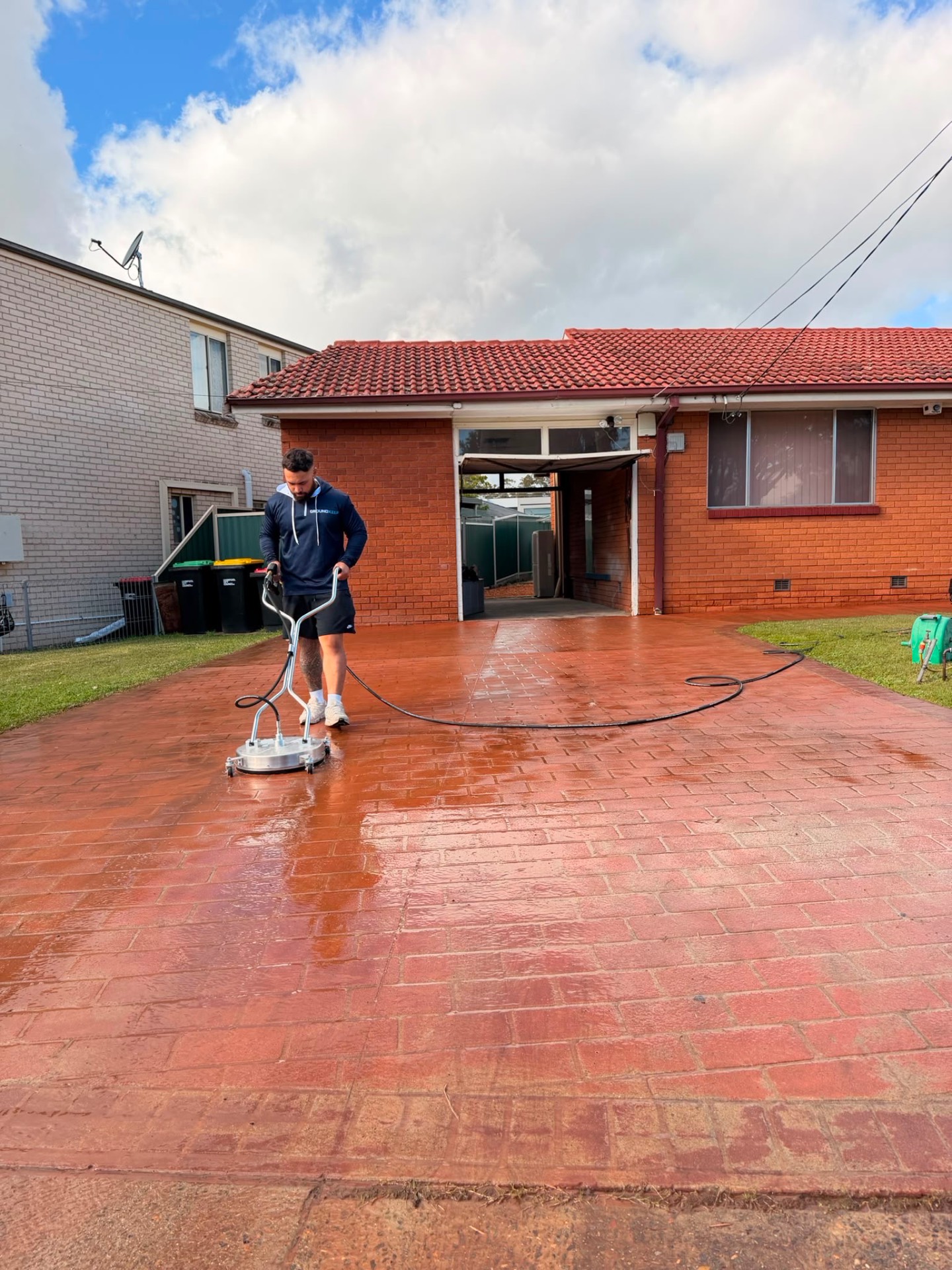 Rotary surface cleaner resetting a stamped concrete driveway, Sydney